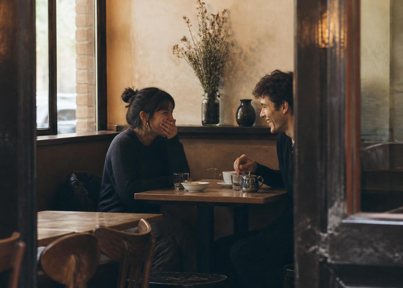 Two people at a small table on a first date